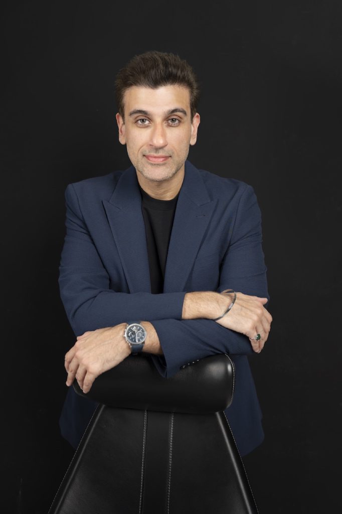 Executive in a navy blazer on a dark backdrop