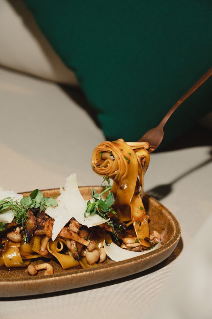 Fresh pasta lifted from a plate