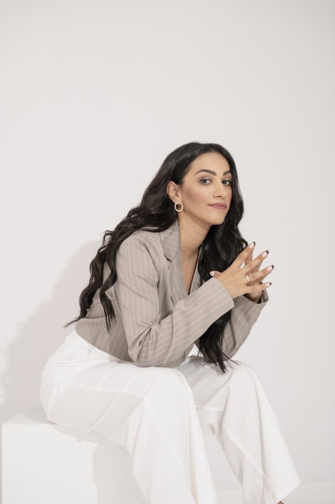 Consultant in a beige blazer, seated