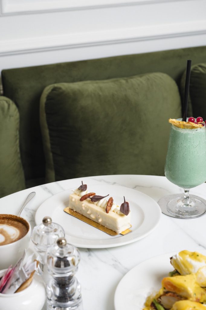 Plated dessert and green drink on a marble table