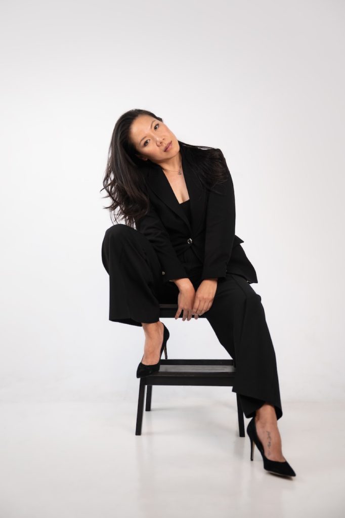 Professional in a black suit on a studio chair