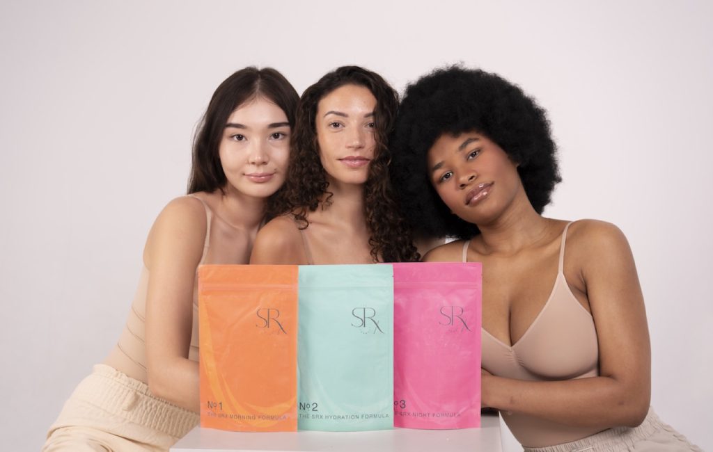 Three models with skincare pouches