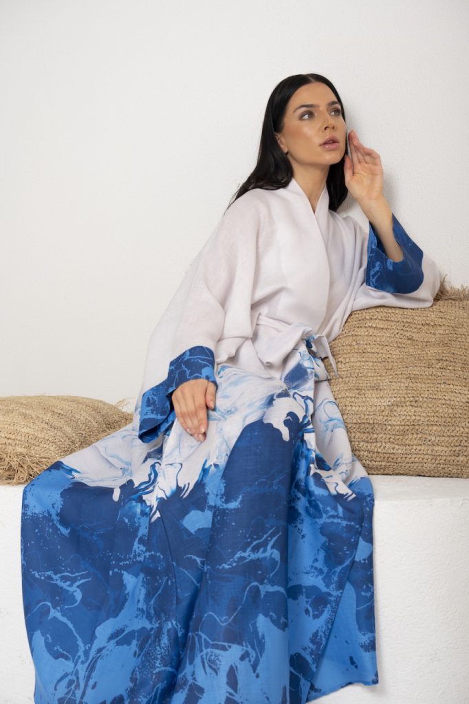 Model in a blue kaftan on a woven chair