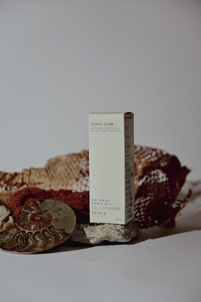 Skincare bottle styled with a shell